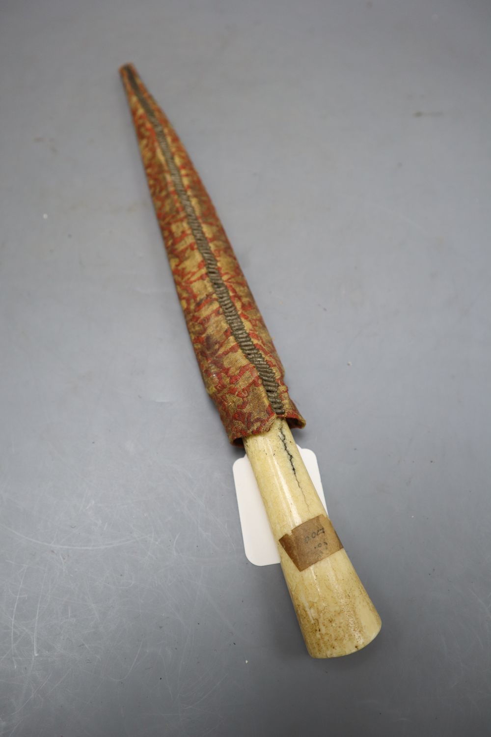 A Persian kard, bolsters and root of blade gold-inlaid with inscriptions, walrus tusk hilt, length blade point to end of handle 34cm